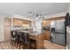 Updated kitchen features granite counters, stainless steel appliances and breakfast bar seating at 3636 W Crocus Dr, Phoenix, AZ 85053