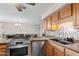 Kitchen features updated stainless steel appliances and a breakfast bar at 3636 W Crocus Dr, Phoenix, AZ 85053