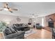 Bright living room with a brick fireplace, ceiling fans, comfortable seating, and plenty of natural light at 3636 W Crocus Dr, Phoenix, AZ 85053
