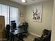 Office space featuring a desk, chair, computer, window, and artwork at 3677 E Park Ave, Gilbert, AZ 85234