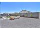 View of the backyard with lounge chairs and fire pit at 37903 W San Clemente St, Maricopa, AZ 85138