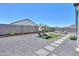Backyard with lounge chairs, artificial turf, and gravel landscaping at 37903 W San Clemente St, Maricopa, AZ 85138