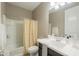 Cozy bathroom with a shower-tub combination, a white vanity, and neutral decor for a relaxing ambiance at 37903 W San Clemente St, Maricopa, AZ 85138