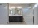Bathroom features double vanity, dark cabinetry, and an enclosed glass shower at 37903 W San Clemente St, Maricopa, AZ 85138