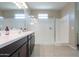 Modern bathroom featuring a double vanity, and frameless glass shower at 37903 W San Clemente St, Maricopa, AZ 85138
