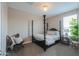 Comfortable bedroom featuring a four-poster bed, stylish chair, and a cozy atmosphere at 37903 W San Clemente St, Maricopa, AZ 85138