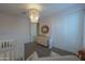 Bedroom with a crib, changing table, and ample closet space illuminated by a beaded chandelier at 37903 W San Clemente St, Maricopa, AZ 85138