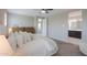 Bright main bedroom features carpet flooring, neutral walls and a view into the bathroom at 37903 W San Clemente St, Maricopa, AZ 85138
