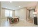 Spacious dining area with tile floors, modern table, and natural light at 37903 W San Clemente St, Maricopa, AZ 85138