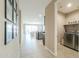 Open-concept entryway with tile flooring and a view of the living area and stainless steel appliances in the kitchen at 37903 W San Clemente St, Maricopa, AZ 85138