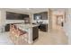 Modern kitchen features granite countertops, stainless steel appliances, and stylish dark wood cabinetry at 37903 W San Clemente St, Maricopa, AZ 85138