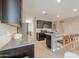 Contemporary kitchen boasts granite counters, tile backsplash, and sleek stainless steel appliances at 37903 W San Clemente St, Maricopa, AZ 85138