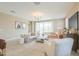 Inviting living room showcases neutral tones, tile floors, a modern chandelier, and backyard access at 37903 W San Clemente St, Maricopa, AZ 85138