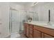 Bright bathroom featuring a glass-enclosed shower, a vanity and a sink at 42310 W Fountainhead St, Maricopa, AZ 85138