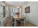 Charming dining room showcasing a chandelier, bay window, and a lovely dining set at 42310 W Fountainhead St, Maricopa, AZ 85138