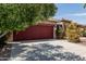 Exterior view of home showcasing the garage, desert landscaping, and mature trees at 42310 W Fountainhead St, Maricopa, AZ 85138