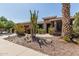 Landscaped front yard with cacti, boulders, desert plants add visual interest to this desert home at 42310 W Fountainhead St, Maricopa, AZ 85138