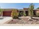 Charming home featuring a beautifully landscaped front yard with desert plants and decorative rock at 42310 W Fountainhead St, Maricopa, AZ 85138