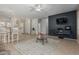 Open-concept living room boasts neutral tones, tile floors, and a stylish entertainment center at 42310 W Fountainhead St, Maricopa, AZ 85138