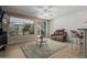 Cozy living room with tile floors, ceiling fan, and sliding glass door to the backyard at 42310 W Fountainhead St, Maricopa, AZ 85138