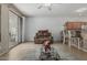Bright living room featuring a comfortable sofa, glass coffee table, and access to the patio at 42310 W Fountainhead St, Maricopa, AZ 85138