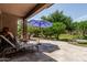 Covered patio featuring a stone pillar, patio furniture, and landscaping at 42310 W Fountainhead St, Maricopa, AZ 85138