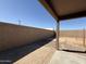 Backyard featuring a block wall and concrete patio, perfect for outdoor entertaining at 43213 W Cowpath Rd, Maricopa, AZ 85138
