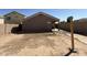 Large, bare dirt backyard featuring a block wall and covered patio at 43213 W Cowpath Rd, Maricopa, AZ 85138