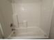A close-up of the bathtub and shower at 43213 W Cowpath Rd, Maricopa, AZ 85138