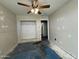 Bedroom with ceiling fan, closet and walk through to another room at 43213 W Cowpath Rd, Maricopa, AZ 85138