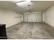 Large, empty two-car garage offers ample space for vehicles and storage at 43213 W Cowpath Rd, Maricopa, AZ 85138
