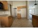 Well-lit kitchen featuring light wood cabinetry, open design, and tile flooring at 43213 W Cowpath Rd, Maricopa, AZ 85138