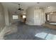 Spacious living room flowing into kitchen with views into other rooms at 43213 W Cowpath Rd, Maricopa, AZ 85138