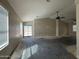 Spacious living room with patio access, ceiling fans, and natural light at 43213 W Cowpath Rd, Maricopa, AZ 85138