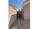 Gate between neighboring homes in a landscaped side yard at 43213 W Cowpath Rd, Maricopa, AZ 85138