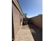 Side yard with rock landscaping, an air conditioner and brick pavers at 43213 W Cowpath Rd, Maricopa, AZ 85138