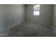 A bedroom with concrete floors, white walls and a bright window with great views at 47706 W Moeller Rd, Maricopa, AZ 85139