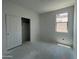 Bedroom with concrete flooring, sliding-door closet and natural light from the bright window at 47706 W Moeller Rd, Maricopa, AZ 85139