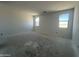 Spacious bedroom showcasing natural light through two windows in an unfinished home at 47706 W Moeller Rd, Maricopa, AZ 85139