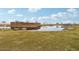 Scenic entrance to Amarillo Creek, featuring a water feature, rock landscaping, and lush green lawn at 47706 W Moeller Rd, Maricopa, AZ 85139