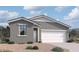Charming single-story home with a gray exterior, manicured landscaping, and a two-car garage at 47706 W Moeller Rd, Maricopa, AZ 85139