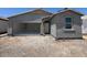 Newly constructed single-story home featuring an attached garage and a classic front door at 47706 W Moeller Rd, Maricopa, AZ 85139