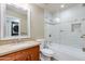 Bright bathroom with a cherry wood vanity, granite countertop, and a modern shower-tub combination at 6138 N 28Th St, Phoenix, AZ 85016
