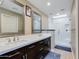 Modern bathroom with dual sinks, dark wood cabinets, and a sleek glass-enclosed shower at 6138 N 28Th St, Phoenix, AZ 85016
