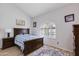 Comfortable bedroom featuring vaulted ceilings, plantation shutter window, and rich wooden furniture at 6138 N 28Th St, Phoenix, AZ 85016