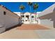 Stunning Spanish-style home with terracotta roof, white stucco walls, and palm trees, embodying elegance at 6138 N 28Th St, Phoenix, AZ 85016