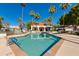 Sparkling community pool surrounded by palm trees and comfortable lounge seating at 6138 N 28Th St, Phoenix, AZ 85016