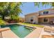Backyard view with pool, lounge chairs and outdoor grill at 7169 S Dodane Ct, Gilbert, AZ 85298