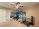 Neutral bedroom with a metal bunk bed over a desk, a ceiling fan, and a sliding door closet at 7169 S Dodane Ct, Gilbert, AZ 85298