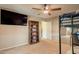 Bedroom including loft bed, a bookcase, and a TV mounted on the wall creating a functional and cozy space at 7169 S Dodane Ct, Gilbert, AZ 85298